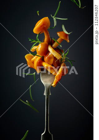 Pickled honey mushrooms sprinkled with rosemary. 112846207
