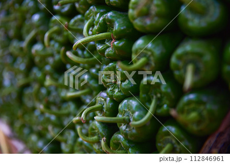 Green pepper on the counter of the Egyptian market. Fresh vegetables in the street bazaar. 112846961