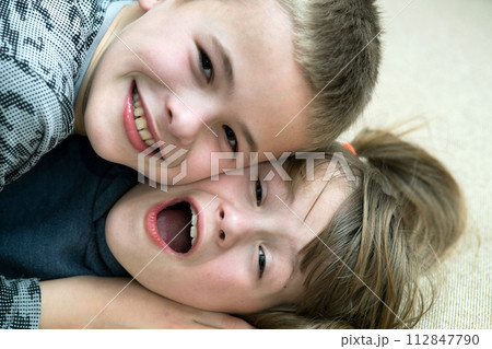 Two children boy and girl fooling around having fun together. Happy childhood concept. Two children boy and girl fooling around having fun together. Happy childhood concept. 112847790