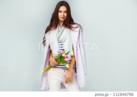 Fashion photo of beautiful woman with tulips in her hand. March 8. beautiful girl in stylish clothes 112848786