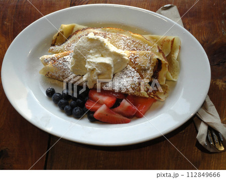 Sweet Crepes Served with sugar ice cream, blueberries and Strawberries 112849666