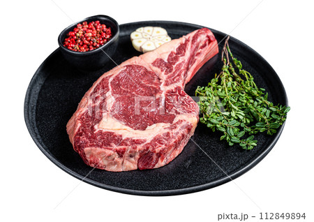 Dry aged cowboy or rib eye steak, raw beef meat with herbs Isolated on white background. Top view. 112849894