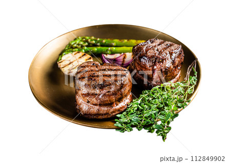 BBQ grilled Fillet Mignon Steak with asparagus, beef tenderloin meat. Isolated on white background. Top view. BBQ grilled Fillet Mignon Steak with asparagus, beef tenderloin meat. Isolated on white background. Top view. 112849902