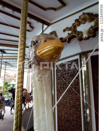 A beautiful ostrich head as part of a seat on a carousel ride A beautiful ostrich head as part of a seat on a carousel ride 112849956
