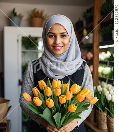 Muslim woman florist collects bouquet of tulips- fresh cut flowers in boxes and vases in flower shop and racks for sale, delivery for the holiday. Spring, March 8, women's Day, birthday. AI generated 112853970