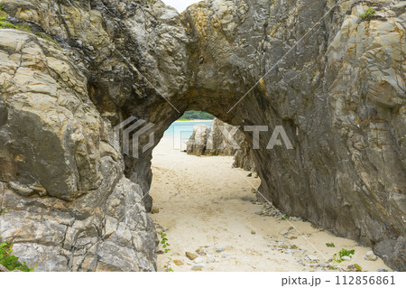 Natural stone arch of Aharen beach in Tokashiki Island, Okinawa, Japan. 112856861