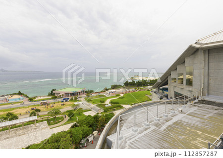 Okinawa Churaumi Aquarium with ocean in the background in Okinawa, Japan Okinawa Churaumi Aquarium with ocean in the background in Okinawa, Japan 112857287