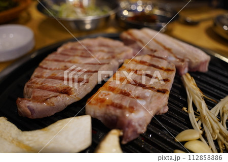 Grilled pork belly on the grill in the restaurant Grilled pork belly on the grill in the restaurant 112858886