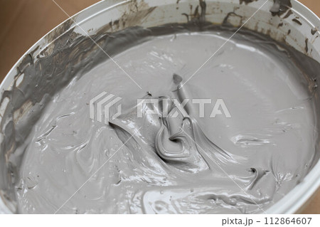 Open bucket full of moisture insulation. A container for a large amount of liquid substances. Open bucket full of moisture insulation. A container for a large amount of liquid substances. 112864607