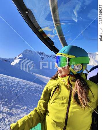Skier Enjoying Gondola Ride Over Snowscapes Skier Enjoying Gondola Ride Over Snowscapes 112866027