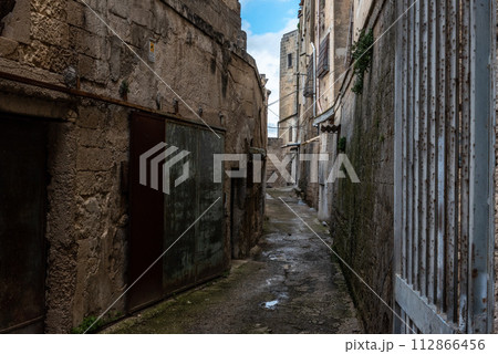An empty path with old derelict houses in the center of Gargano, Italy An empty path with old derelict houses in the center of Gargano, Italy 112866456