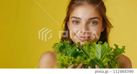 AI-generated content. Smiling Young Woman Holding Fresh Green Lettuce Against a Yellow Background 112868390