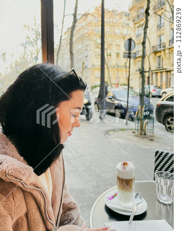 Coffee with ice cream and whipped cream on the table in Paris, France. French toast with ice cream and caramelized bananas on a plate. 112869239