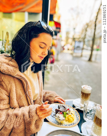 Coffee with ice cream and whipped cream on the table in Paris, France. French toast with ice cream and caramelized bananas on a plate. 112869251