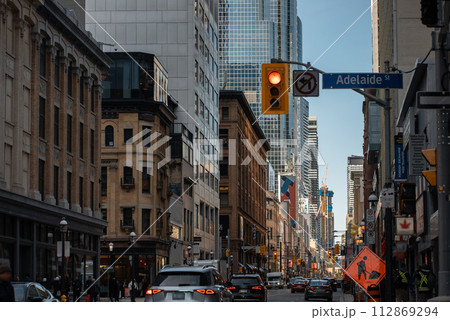 busy city street of New York or Toronto downtown district, urban view of American megapolis busy city street of New York or Toronto downtown district, urban view of American megapolis 112869294