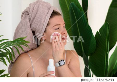 Skincare routine with toner and cotton pad Skincare routine with toner and cotton pad 112870244
