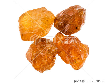 few unpolished hessonite crystals isolated few unpolished hessonite crystals isolated 112870562