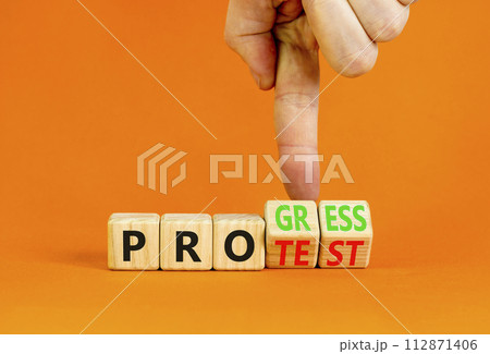 Progress vs protest symbol. Concept word Progress Protest on beautiful wooden cubes. Beautiful orange table orange background. Businessman hand. Business progress vs protest concept. Copy space. Progress vs protest symbol. Concept word Progress Protest on beautiful wooden cubes. Beautiful orange table orange background. Businessman hand. Business progress vs protest concept. Copy space. 112871406