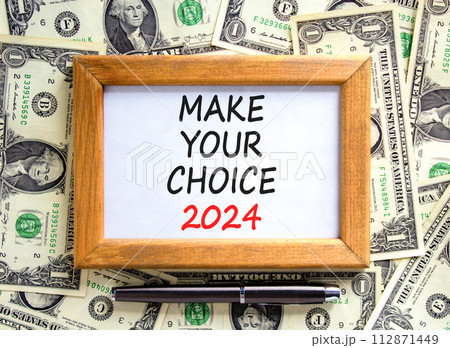 Make your choice 2024 symbol. Concept words Make your choice 2024 on beautiful wooden frame. Beautiful dollar bills background. Dollar bills. Business Make your choice 2024 concept. Copy space. 112871449