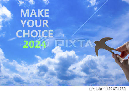 Make your choice 2024 symbol. Concept words Make your choice 2024. Beautiful blue sky cloud background. Voter hand with wooden bird. Business Make your choice 2024 concept. Copy space Make your choice 2024 symbol. Concept words Make your choice 2024. Beautiful blue sky cloud background. Voter hand with wooden bird. Business Make your choice 2024 concept. Copy space 112871453