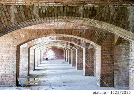 Endless brick passage with repeating archways in Fort Jefferson on Dry Tortugas National Park. Endless brick passage with repeating archways in Fort Jefferson on Dry Tortugas National Park. 112872850