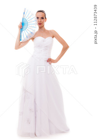 Full length bride in wedding gown holds fan isolated Full length bride in wedding gown holds fan isolated 112873439