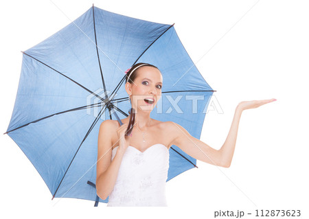Pretty bride woman in white dress holding umbrella 112873623