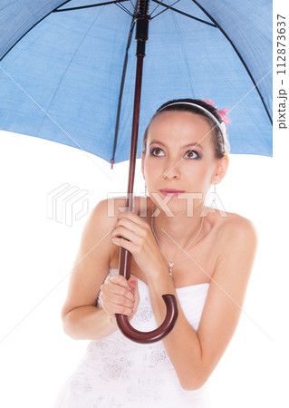 Bride woman hiding taking cover under umbrella Bride woman hiding taking cover under umbrella 112873637