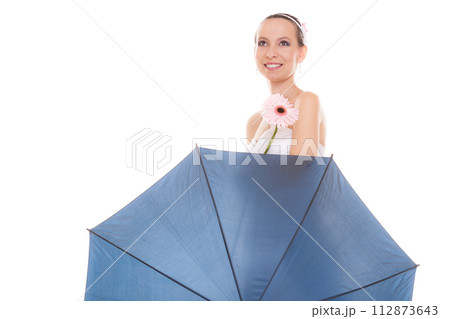 Happy bride woman holding umbrella and flower. 112873643