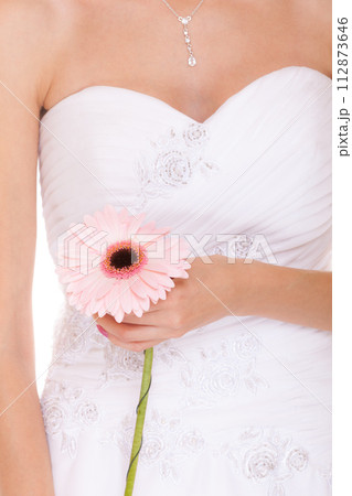 Closeup of bride white wedding dress with flower 112873646