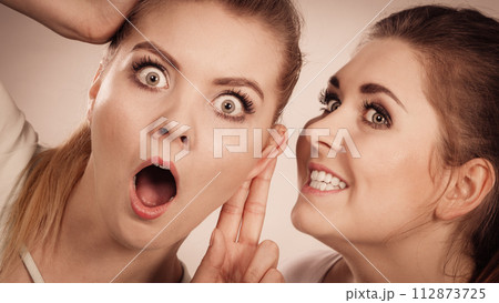 Two women telling gossip 112873725