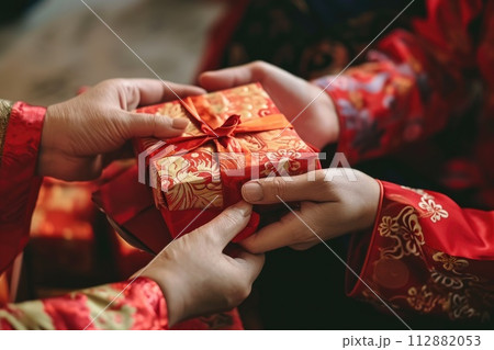 Chinese new year celebration, Cropped shot of hand receiving red envelopes from their parent 112882053