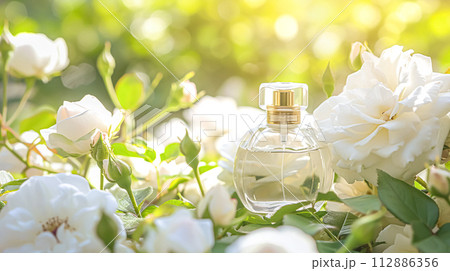 Perfume bottle in flowers, fragrance on blooming background, floral scent and cosmetic product 112886356