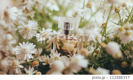Perfume bottle in flowers, fragrance on blooming background, floral scent and cosmetic product 112886357