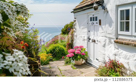 White coastal cottage in the English countryside style by the seaside White coastal cottage in the English countryside style by the seaside 112886375