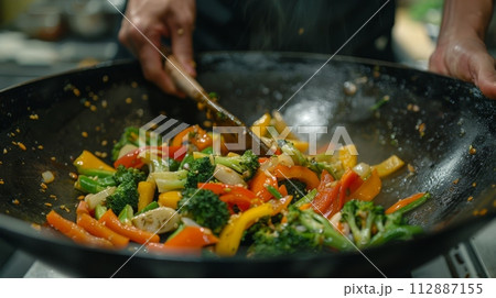 AI-generated content. Chef stir-frying colorful vegetables in a wok 112887155