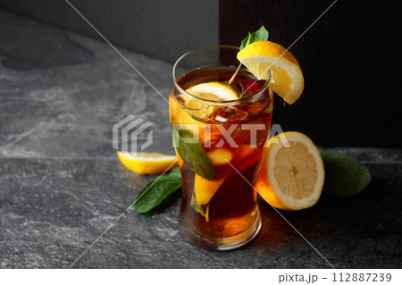 Iced tea or a summer refreshing drink with ice, mint, and lemon. 112887239