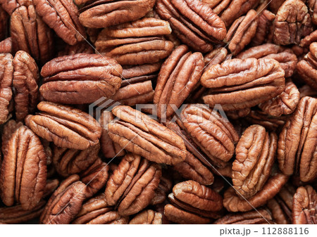 Raw peeled brown pecan nuts top view macro background. Raw peeled brown pecan nuts top view macro background. 112888116