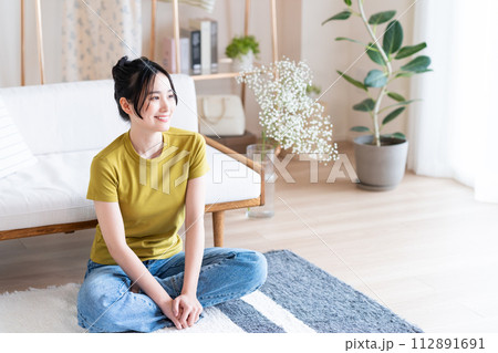 リビングでくつろぐ若い女性 リビングでくつろぐ若い女性 112891691