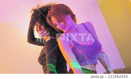 Sensual dance of friends in a home party at night Sensual dance of friends in a home party at night 112892058