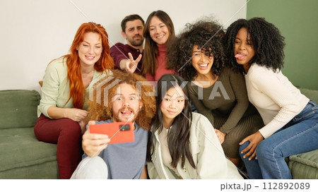 Multi-ethnic friends taking a selfie at home 112892089