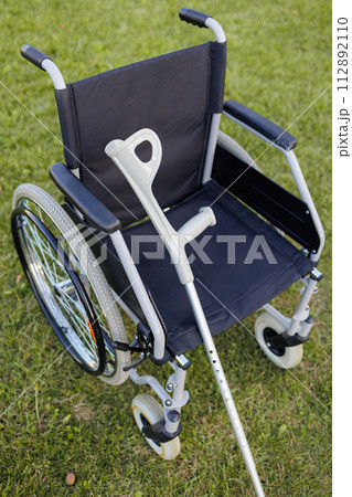 Empty Wheelchairs and Crutches in Nature 112892110