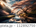 夕日に照らされる桜と静かな山と川 112892750