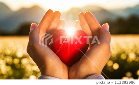 Woman Hands Holding a Red Heart Illuminated by the Sun - Generative Ai 112892986