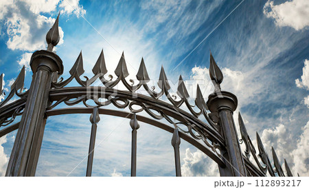Wrought Iron Gate with Sharp Points on Blue Sky with Clouds - Generative Ai 112893217
