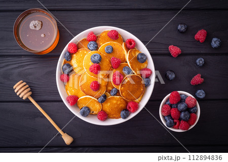 Mini pancakes with berries . Delicious breakfast . 112894836