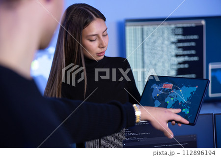 Cyber security team working in a Cyber Security Operations Center SOC to protect systems and technologies Cyber security team working in a Cyber Security Operations Center SOC to protect systems and technologies 112896194