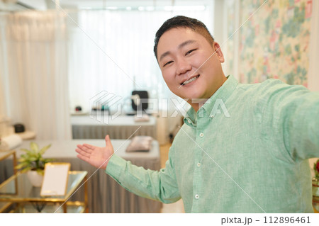 Cheerful wax salon owner filming rooms review for social media Cheerful wax salon owner filming rooms review for social media 112896461