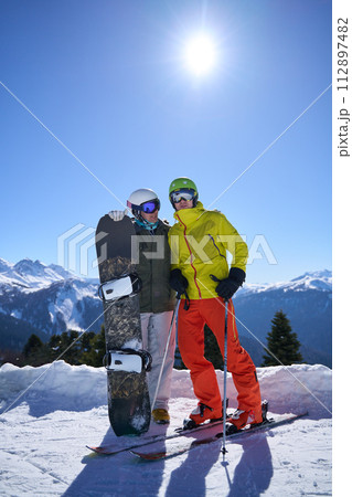 Skier and Snowboarder Enjoying Mountain View Skier and Snowboarder Enjoying Mountain View 112897482