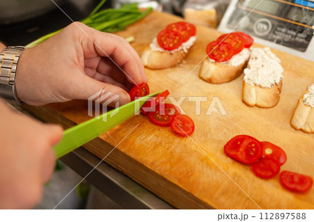 Bruschetta with tomatoes, Philadelphia cheese, sausage, dill and olive oil. 112897588